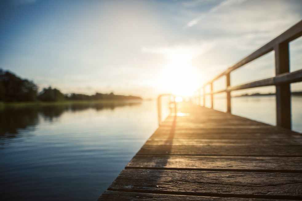 low angle photography of brown wooden dock at golden house